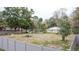 Large backyard with a partial fence, various trees, a shed, and a white vehicle at 70 Se 81St Pl, Ocala, FL 34480