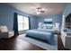 Main bedroom with a king-size bed and wood-look floors at 70 Se 81St Pl, Ocala, FL 34480