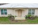 Light brown front door with arched entryway and small porch at 70 Se 81St Pl, Ocala, FL 34480