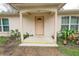 Light brown front door with arched entryway and small porch at 70 Se 81St Pl, Ocala, FL 34480
