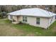 Tan single story home with metal roof and small lawn at 70 Se 81St Pl, Ocala, FL 34480