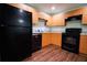 Galley kitchen with wood cabinets and black appliances at 70 Se 81St Pl, Ocala, FL 34480