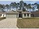 Newly constructed home with a two-car garage and a landscaped front yard at 7661 Sw 180Th Cir, Dunnellon, FL 34432