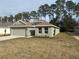 Newly built home showcasing a neutral color palette and a spacious front yard at 7661 Sw 180Th Cir, Dunnellon, FL 34432