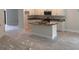 Modern kitchen with island, granite countertops, and white cabinets at 7661 Sw 180Th Cir, Dunnellon, FL 34432
