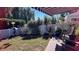 Landscaped backyard with white fence, greenery, and a brick pathway at 7729 Sw 85Th Cir, Ocala, FL 34481