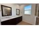 Double vanity bathroom with large mirrors and a walk-in shower at 7729 Sw 85Th Cir, Ocala, FL 34481