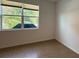 Empty bedroom with large window and tile flooring at 7729 Sw 85Th Cir, Ocala, FL 34481