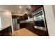 Modern kitchen with stainless steel appliances and dark wood cabinets at 7729 Sw 85Th Cir, Ocala, FL 34481
