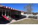 Outdoor patio with seating, grill, and hammock under a striped awning at 7729 Sw 85Th Cir, Ocala, FL 34481