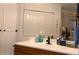 Bathroom vanity with wood cabinets and large mirror at 7990 Midway Drive Ter # M102, Ocala, FL 34472