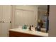 Bathroom vanity with wood cabinets and large mirror at 7990 Midway Drive Ter # M102, Ocala, FL 34472