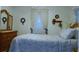 Bedroom with wooden dresser and blue bedding at 7990 Midway Drive Ter # M102, Ocala, FL 34472