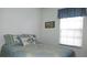 Cozy bedroom with blue floral bedding and window blinds at 7990 Midway Drive Ter # M102, Ocala, FL 34472