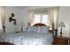Bedroom with wooden bed frame and blue bedding at 7990 Midway Drive Ter # M102, Ocala, FL 34472