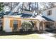 House exterior showcasing white walls, yellow accents, and landscaping at 7990 Midway Drive Ter # M102, Ocala, FL 34472