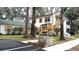 View of the building and surrounding area, showing parking and landscaping at 7990 Midway Drive Ter # M102, Ocala, FL 34472