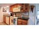 Kitchen with wood cabinets, granite countertops, and modern appliances at 7990 Midway Drive Ter # M102, Ocala, FL 34472