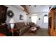 Living room with floral sofa, wooden furniture, and a charming atmosphere at 7990 Midway Drive Ter # M102, Ocala, FL 34472