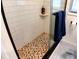 Shower with mosaic tile floor and glass enclosure at 7990 Midway Drive Ter # M102, Ocala, FL 34472
