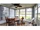 Bright sunroom with table, chairs, and ceiling fan at 7990 Midway Drive Ter # M102, Ocala, FL 34472