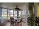 Bright sunroom with table, chairs, and ceiling fan at 7990 Midway Drive Ter # M102, Ocala, FL 34472