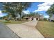 House exterior with a long driveway and mature trees at 8111 Sw 108Th Street Rd, Ocala, FL 34481