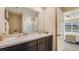 Bathroom with double vanity, shower, and view into bedroom at 8666 Sw 44Th Ter, Ocala, FL 34476