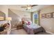 Gray bedroom with a full bed, wood accent wall, and window at 8666 Sw 44Th Ter, Ocala, FL 34476