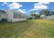 View of the backyard, showing the house and surrounding landscape at 8677 Sw 95Th Ln # C, Ocala, FL 34481