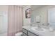 Bathroom with a tub shower combination, gray vanity, and light walls at 8699 Sw 44Th Ter, Ocala, FL 34476