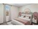 Bedroom with a bed featuring a unique headboard and soft color scheme at 8699 Sw 44Th Ter, Ocala, FL 34476