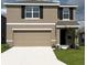 Charming two-story home with a two car garage, black shutters, and manicured lawn at 8699 Sw 44Th Ter, Ocala, FL 34476