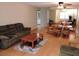 Bright living room with wood floors, comfy seating, and a dining area at 8707 Sw 88Th Court Rd # B, Ocala, FL 34481