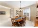 Bright dining room features a wooden table with chairs and a chandelier at 9099 Se 118Th Ln, Summerfield, FL 34491