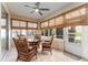 Bright sunroom with a ceiling fan and plenty of natural light at 9099 Se 118Th Ln, Summerfield, FL 34491