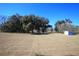 Open grassy backyard with two sheds and trees at 9340 Sw 9Th Ter, Ocala, FL 34476