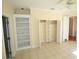 Bedroom with tile flooring, a ceiling fan, walk in closet and built in shelving at 9340 Sw 9Th Ter, Ocala, FL 34476