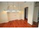 Bright dining area features hardwood floors, modern lighting, and an archway leading to another room at 9340 Sw 9Th Ter, Ocala, FL 34476