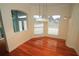 Bright dining room featuring hardwood floors, pendant lighting, and a view of the foyer at 9340 Sw 9Th Ter, Ocala, FL 34476