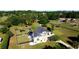 Expansive home with a lush lawn, mature trees and landscaping, and a black fence surrounding the perimeter at 9340 Sw 9Th Ter, Ocala, FL 34476