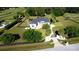 Large home with a circular drive, mature landscaping, and a secure gate, all surrounded by black fencing at 9340 Sw 9Th Ter, Ocala, FL 34476