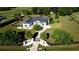 Large home with a circular drive, mature landscaping, and a secure gate, all surrounded by black fencing at 9340 Sw 9Th Ter, Ocala, FL 34476
