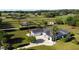 Large home with a pool, expansive lawn, and a black fence surrounding the perimeter at 9340 Sw 9Th Ter, Ocala, FL 34476