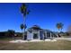 Elegant home featuring a two-story entrance with balcony, columns, and lush landscaping in a well manicured yard at 9340 Sw 9Th Ter, Ocala, FL 34476