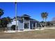 Inviting home featuring a covered balcony, lush landscaping and a circular driveway for easy access and curb appeal at 9340 Sw 9Th Ter, Ocala, FL 34476