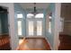Inviting foyer featuring double glass front doors, transom window, decorative sidelights and tile flooring at 9340 Sw 9Th Ter, Ocala, FL 34476