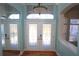 Inviting foyer featuring double glass front doors, transom window, decorative sidelights and tile flooring at 9340 Sw 9Th Ter, Ocala, FL 34476