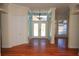 Welcoming foyer featuring double glass front doors, transom window, decorative sidelights, and hardwood flooring at 9340 Sw 9Th Ter, Ocala, FL 34476