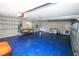 Spacious garage features a blue floor, storage racks and laundry hookups at 9340 Sw 9Th Ter, Ocala, FL 34476